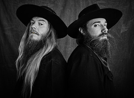 Band members of Mountain Head standing back to back.