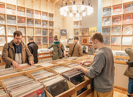 Customers searching through Crates of assorted 12 inch records on display at Tiny Record Shop.