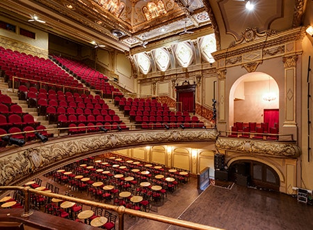 View of Rialto Theatre from mezzanine: Rows of short chairs overlooking the stage.