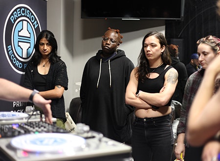 PRP_Qued_Up_3.jpg Spectators watching DJ set.