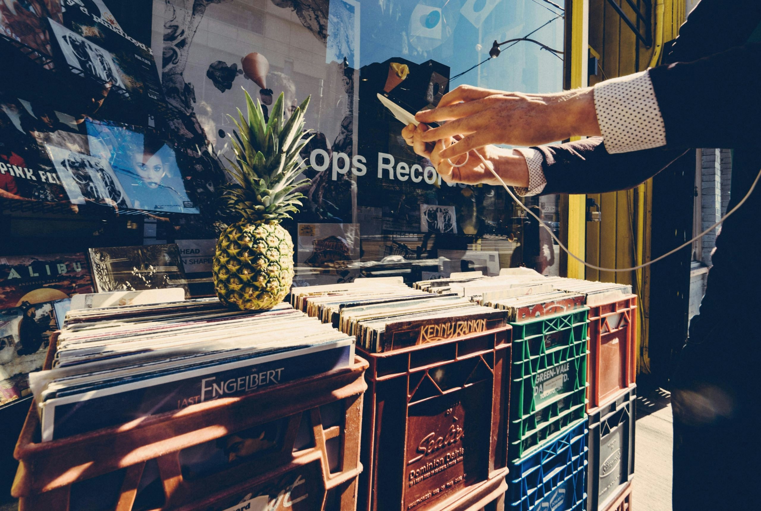 Man browsing through crates of diverse records outside Kops Records