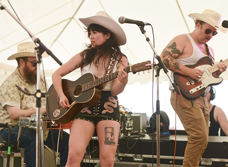 Lead signer, Nicolette Hoang, performing onstage.