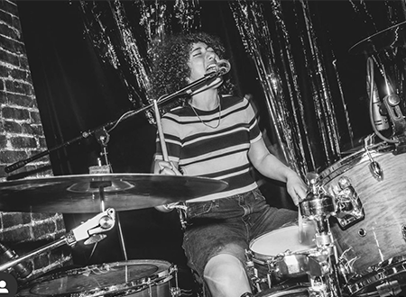 Drummer, Lola Hayman performing onstage.