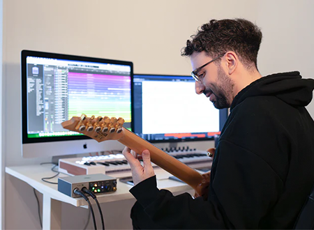 Y2bKgncz-SHP-Transcribing.png Employee at Sheet Happens Productions transcribing guitar music.