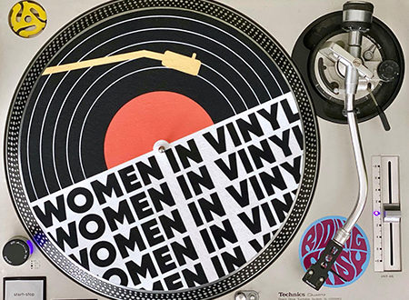 Images of a turntable showing a Women in Vinyl branded slip mat.
