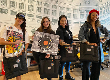 Images of Jenn D'Eugenio and her colleagues holding Women in Vinyl partnered merchandise.