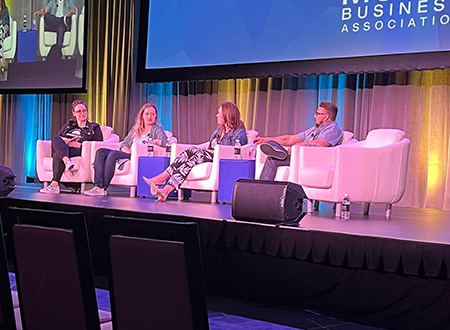 Jenn D'Eugenio moderating a panel of vinyl industry members on stage