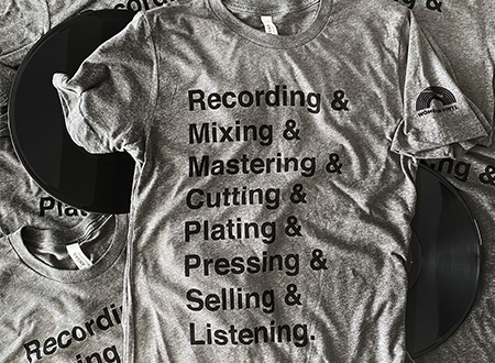 Image of a t-shirt sold by Women in Vinyl featuring a graphic listing the steps of making vinyl records.
