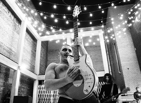 4t9oGcqV-UpHereMarc-Etienne-Mongrain-6.png Member of Diva Worship playing guitar onstage.