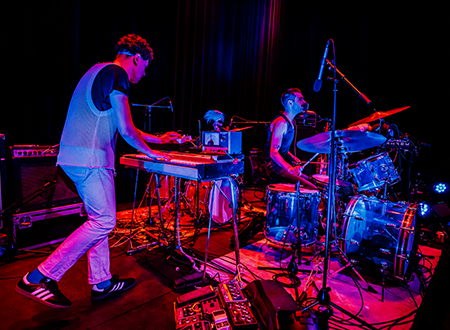 Population II performing onstage.