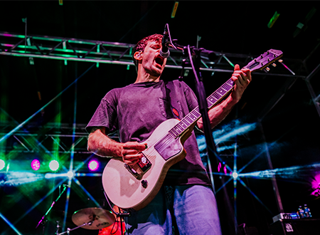 PUP lead guitarist performing onstage.