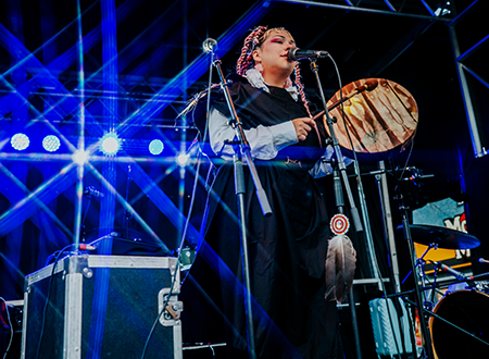 Anachnid performing onstage.