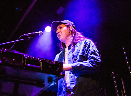 Brayson Wong playing the keyboard onstage.