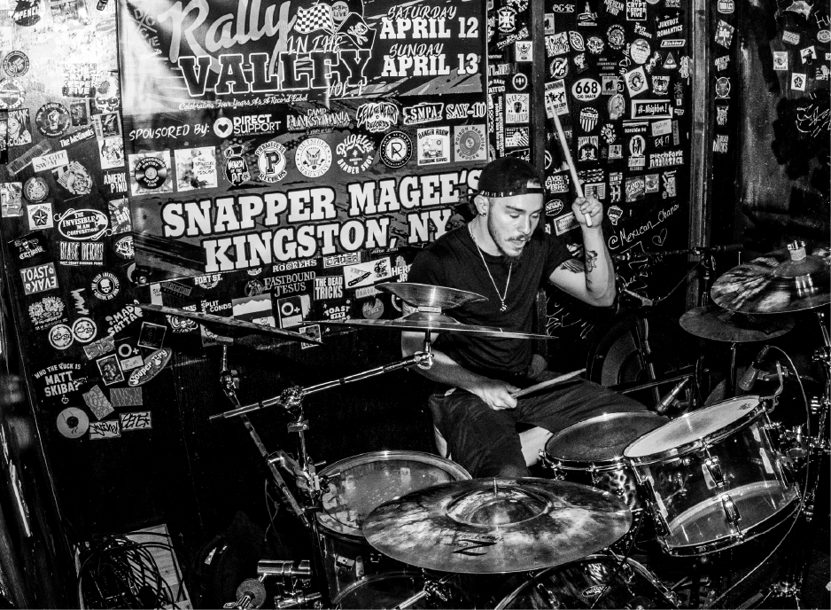 Drummer playing on stage.