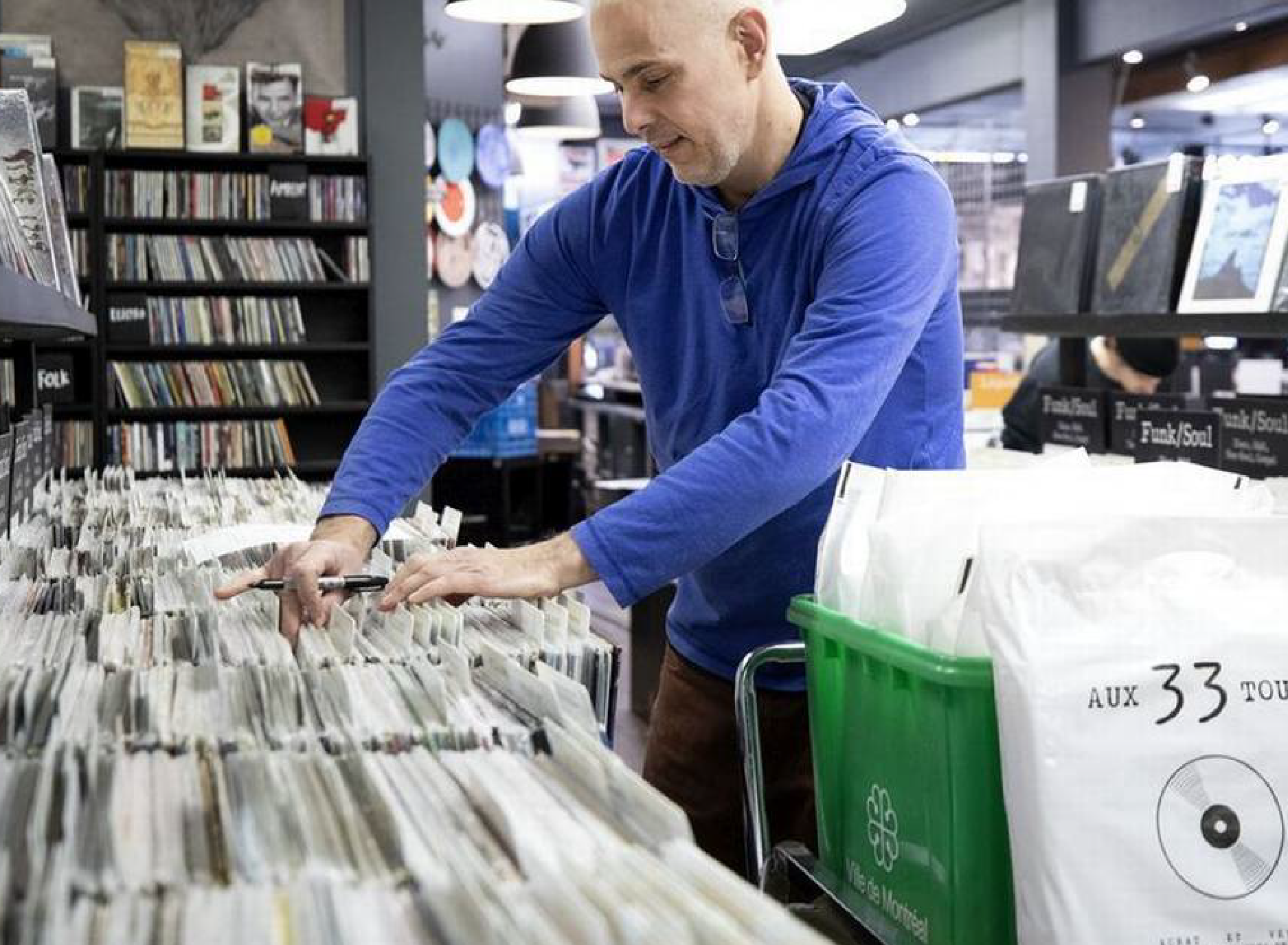 © Allen McInnis (Mark Markotanyos) Mark Markotanyos, owner of Aux 33 Tours looking through records.