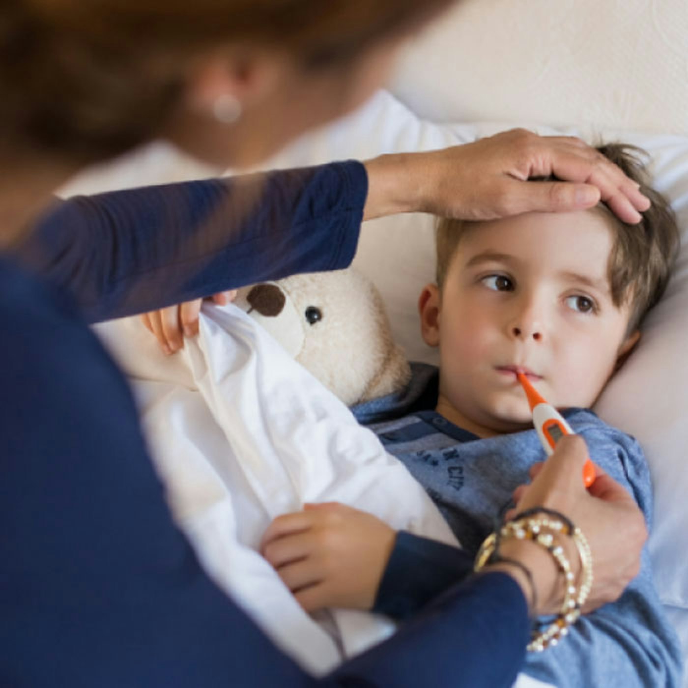 Parent checking their child's temperature