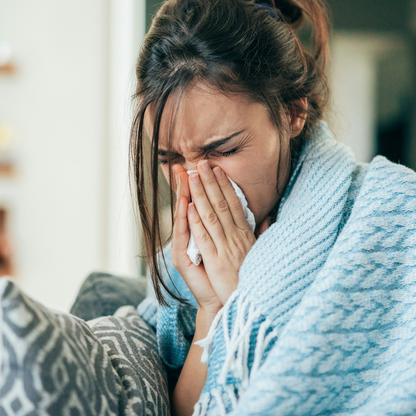 woman blowing her nose