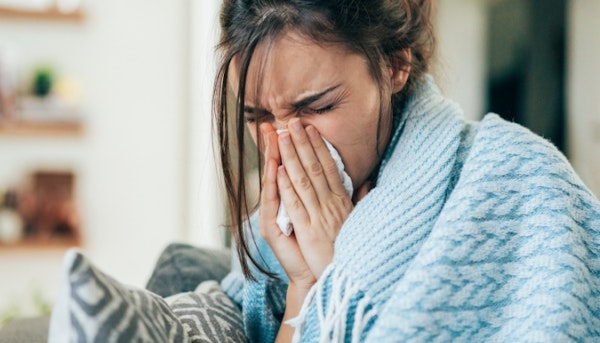 woman blowing her nose