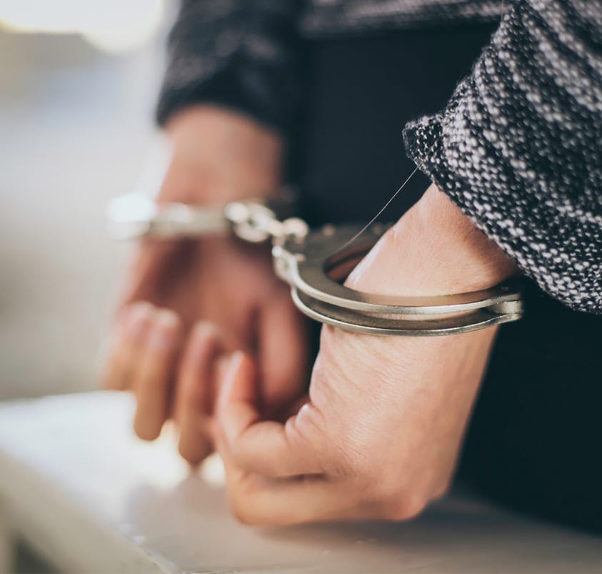 person in handcuffs