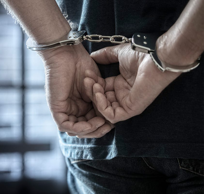 person in handcuffs