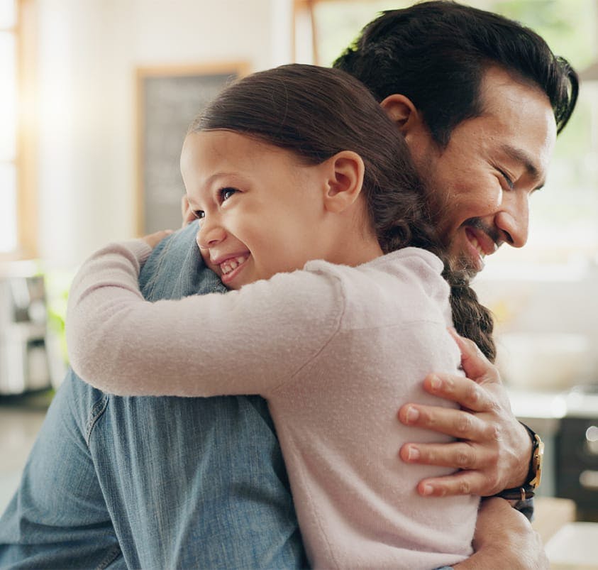 man hugging a little girl