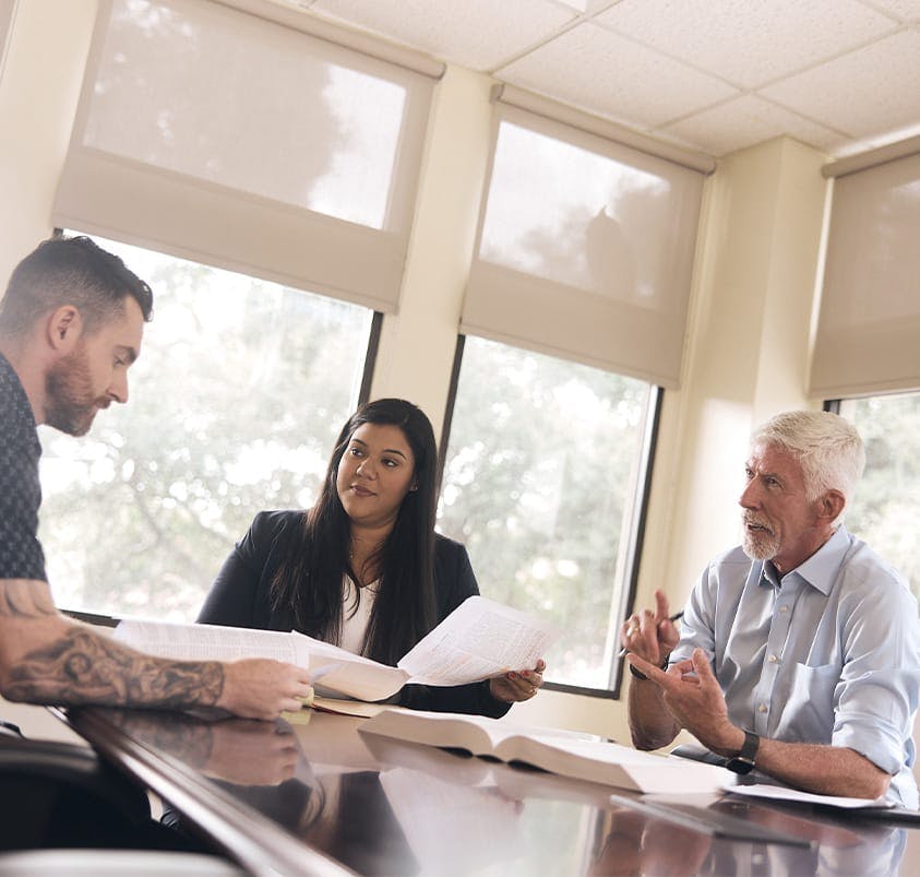 three people talking at a table