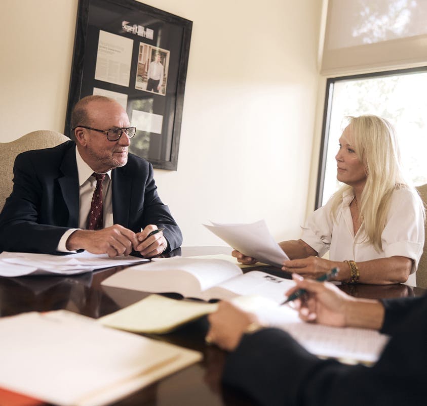 man and woman sitting at a table looking at documents