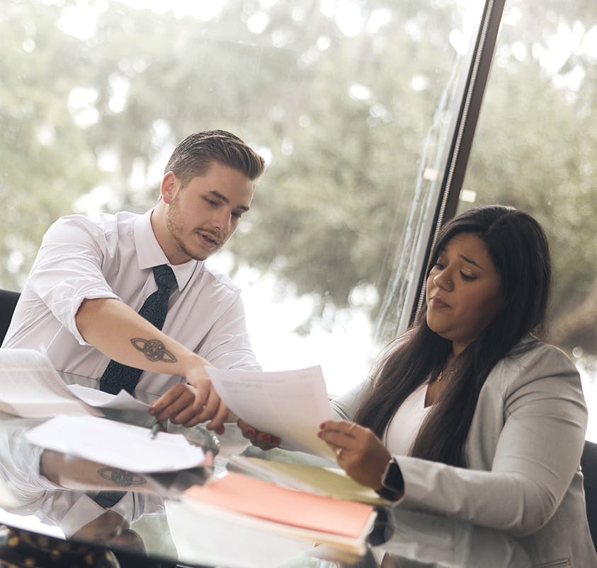 two people looking at documents