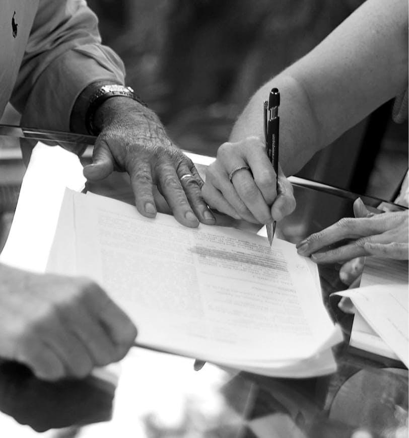 person signing a document