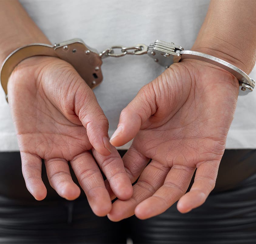 person in handcuffs