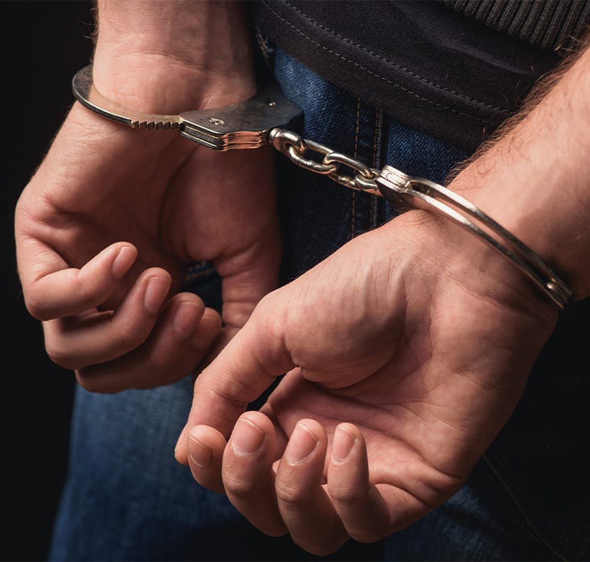 person in handcuffs