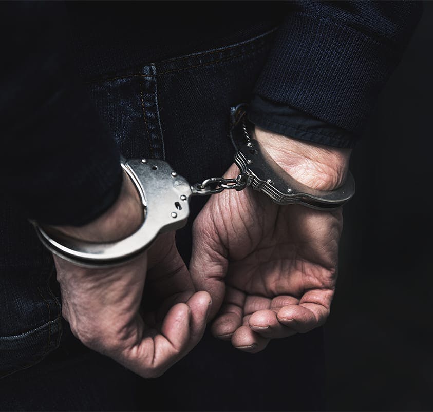 person in handcuffs