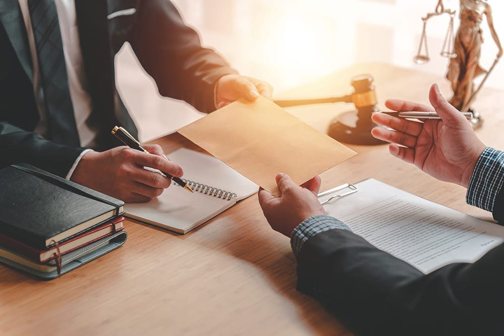 attorney working with a client across a desk