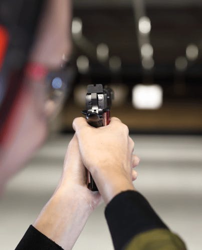 person holding a gun in a gun range