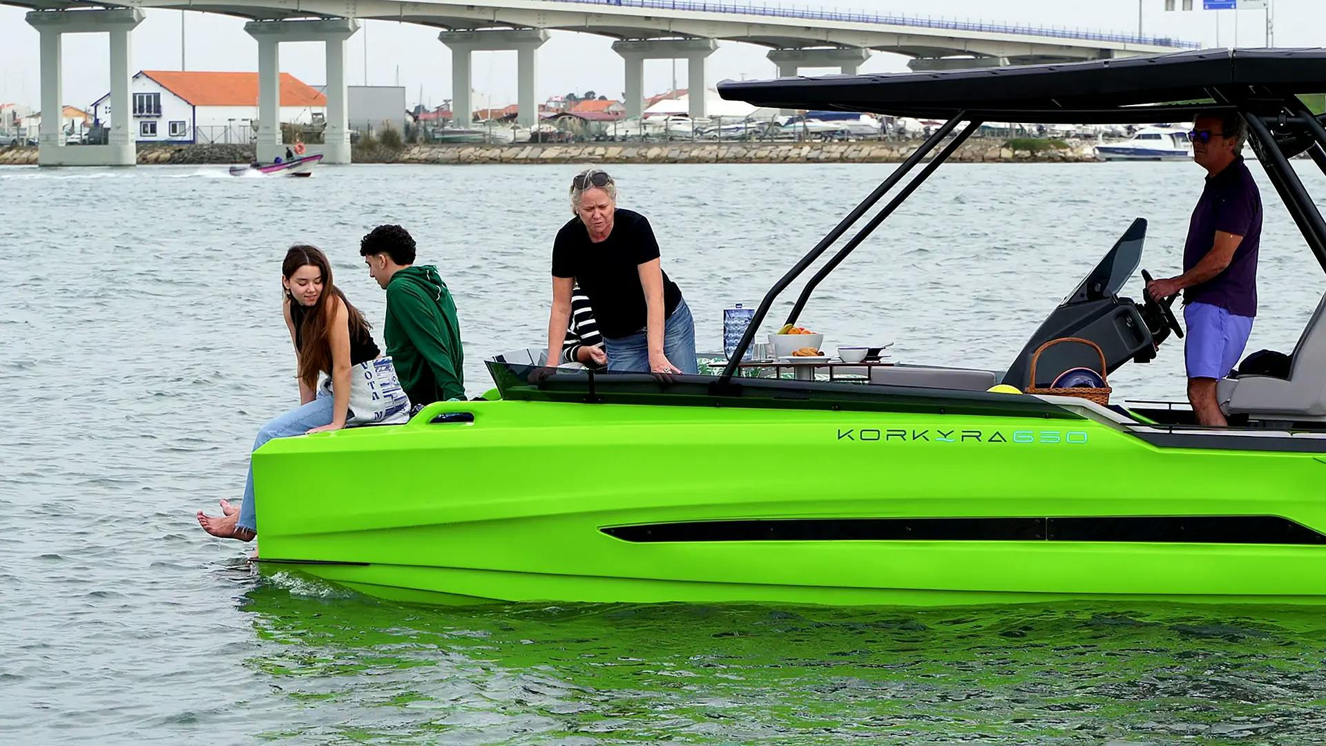 Family relaxing aboard the Korkyra 650 catamaran boat in the harbour.