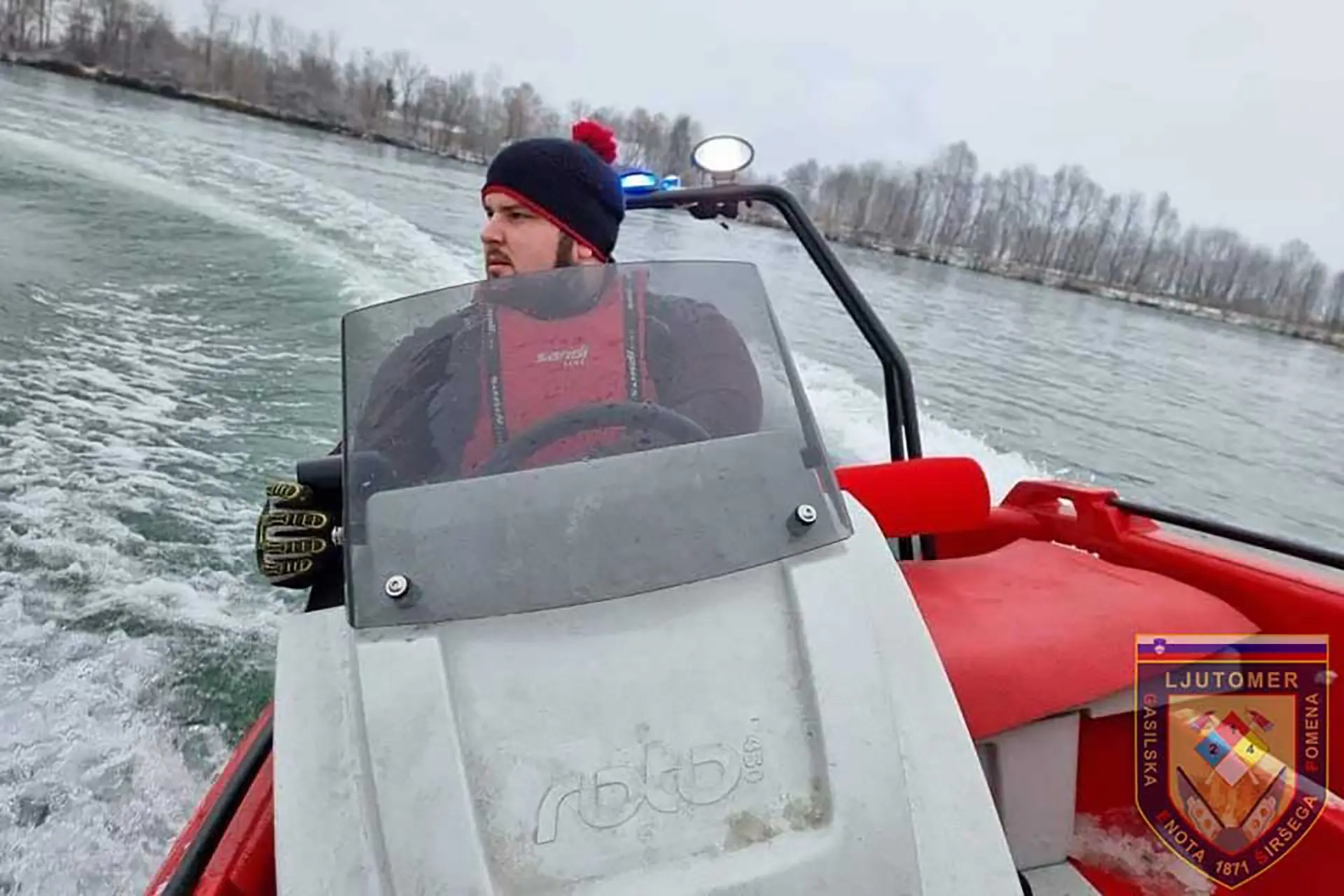 Rescuer steering a coastline rescue boat on a coastal patrol.