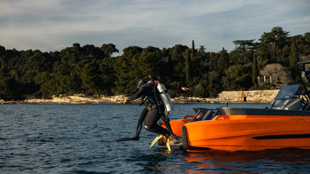 Scuba divers jumping into the sea from the Korkyra scuba boat.