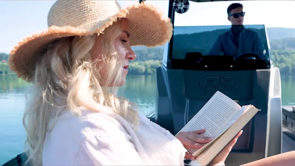 Young woman reading a book aboard the Korkyra 650 catamaran boat