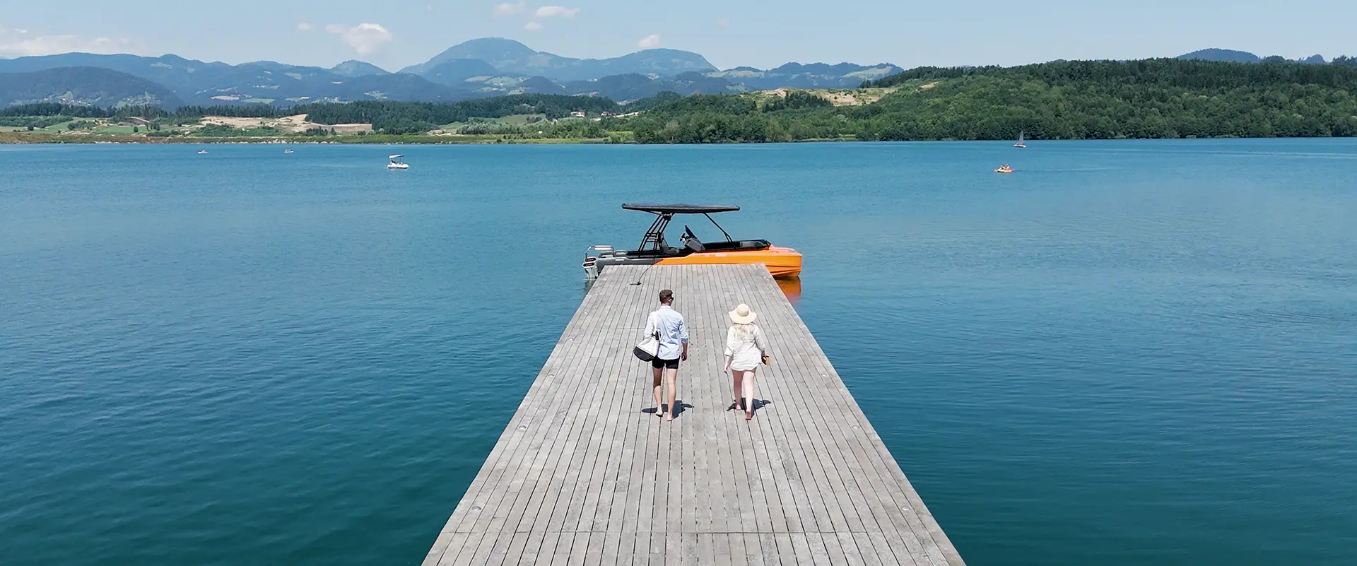 Young couple walking down the pier to board the Korkyra 650 catamaran.