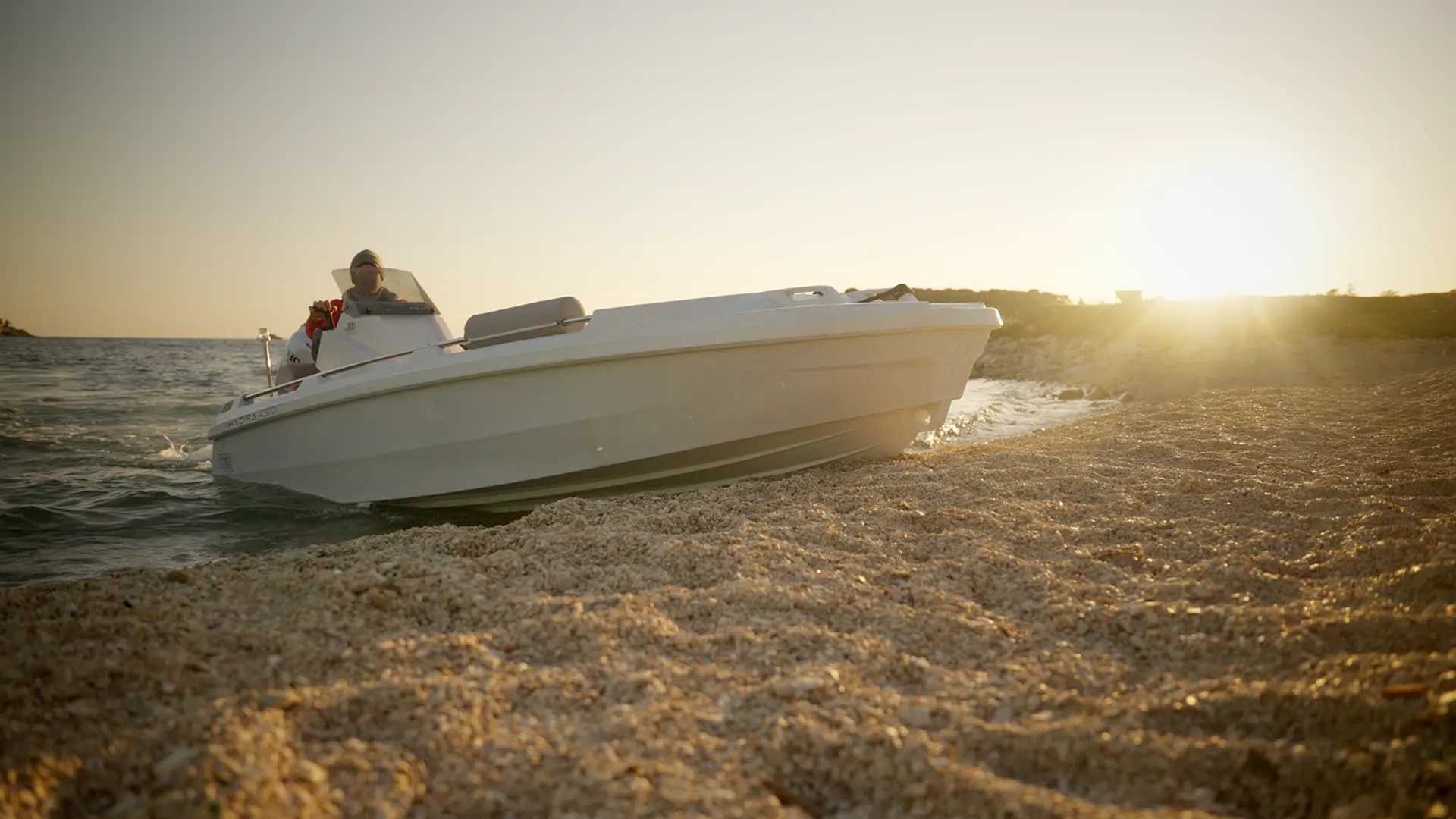 Hydra Roto Nautica boat anchored at a peaceful beach
