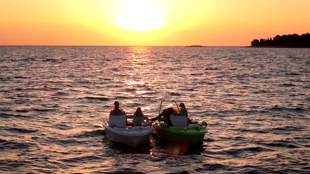 Two Roto Nautica boats at sunset with friends enjoying the ride.