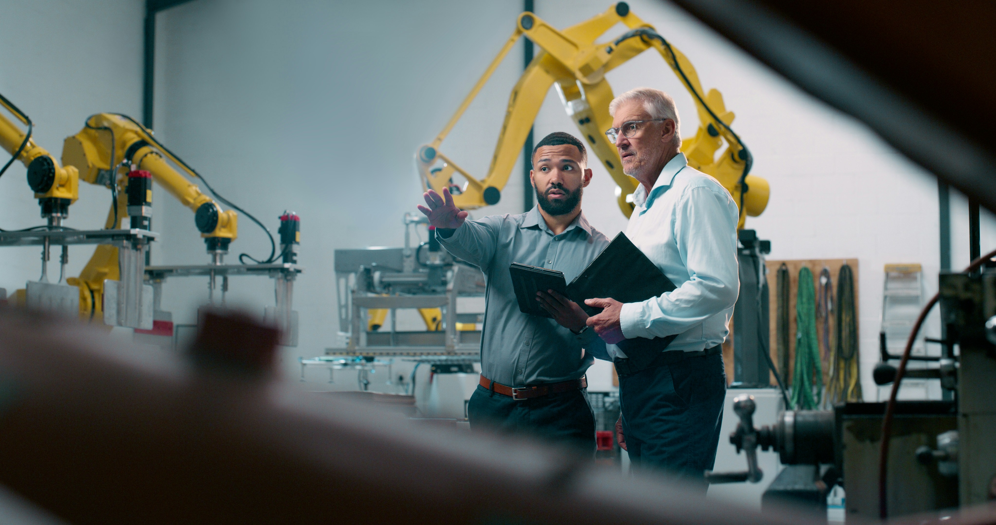 a foreman talking with IT support at a manufacturing plant