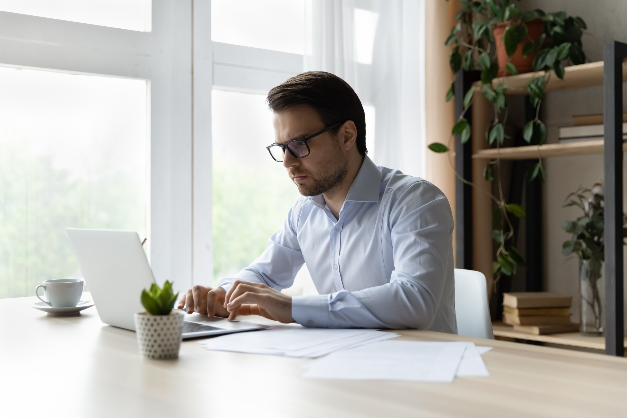 Employee Contacting IT Helpdesk on Their Laptop