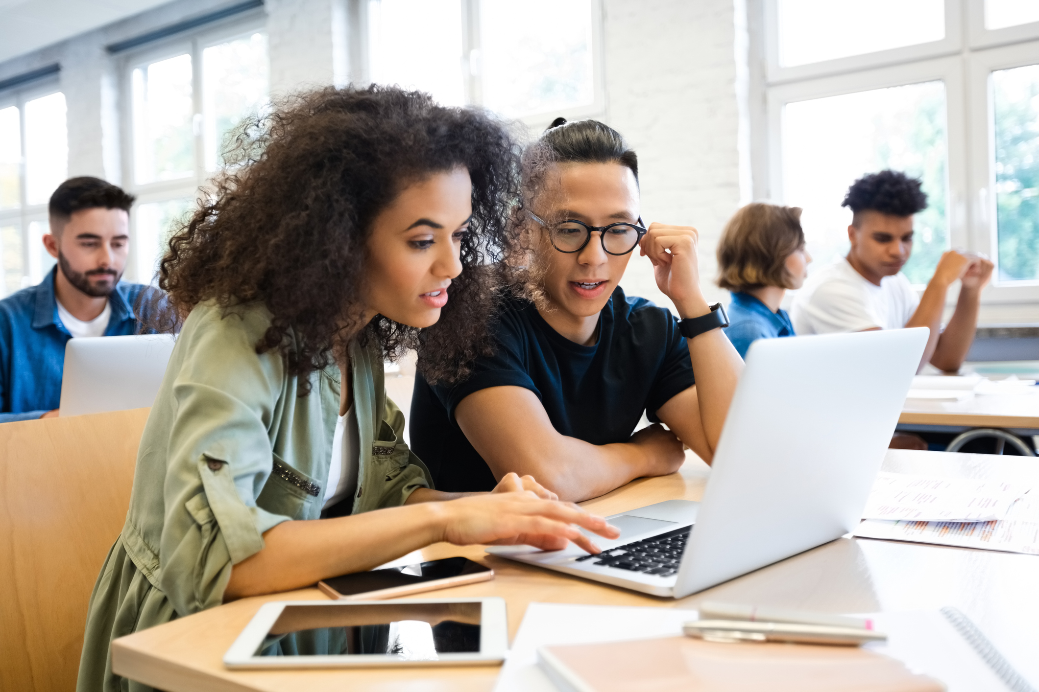 College Students Collaborating on a Project in Classroom