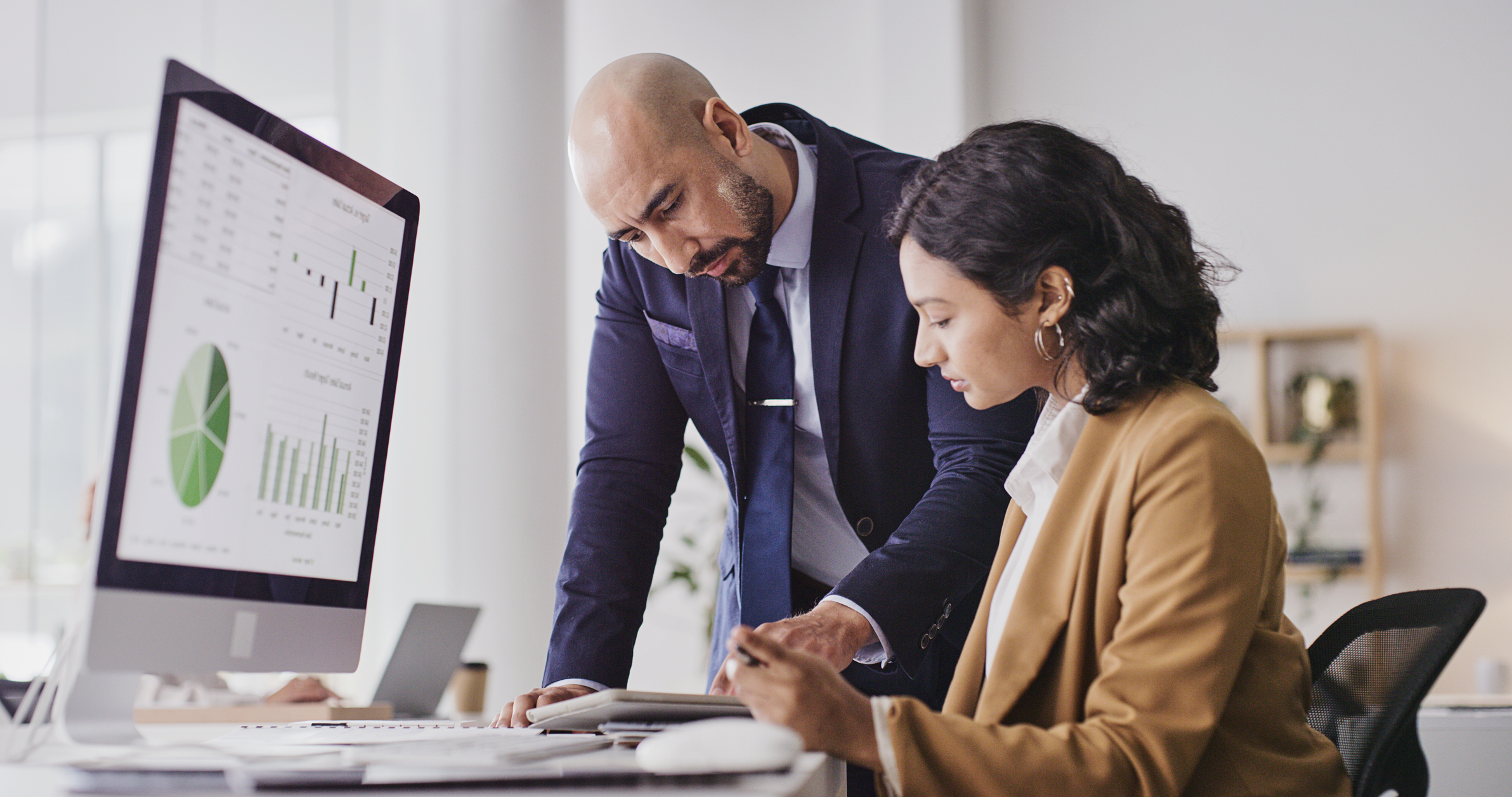 Lawyers Consulting on Case Files at a Computer