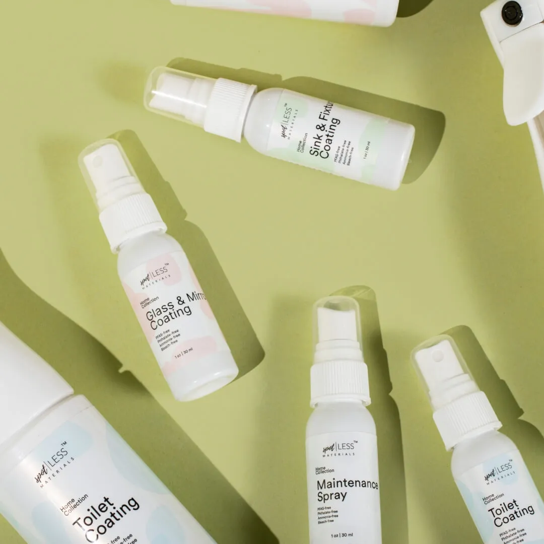 An assortment of cleaning sprays labeled for different purposes, such as 'Toilet Coating' and 'Glass & Mirror Coating,' on a pastel green background