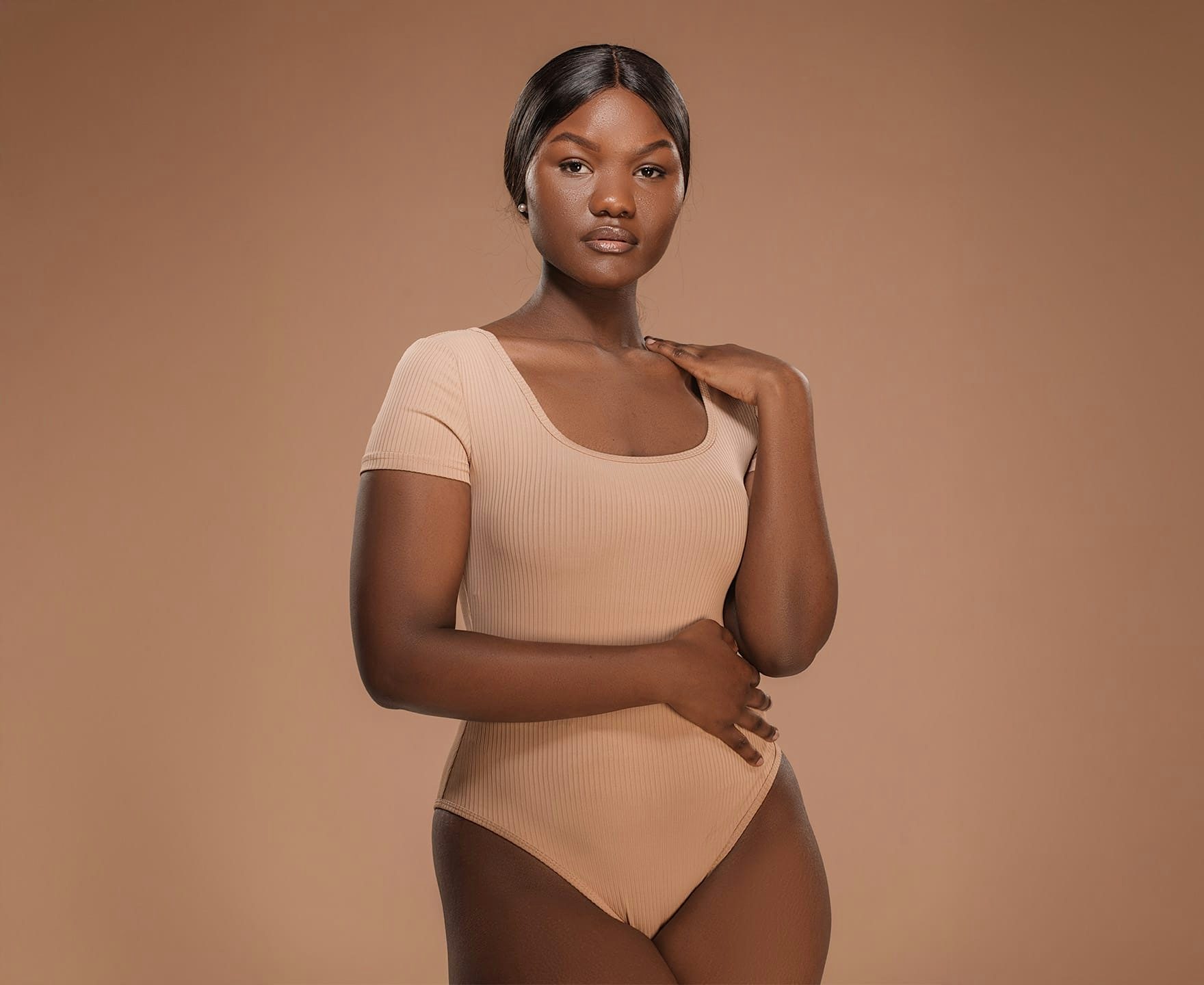 woman posing in tan leotard