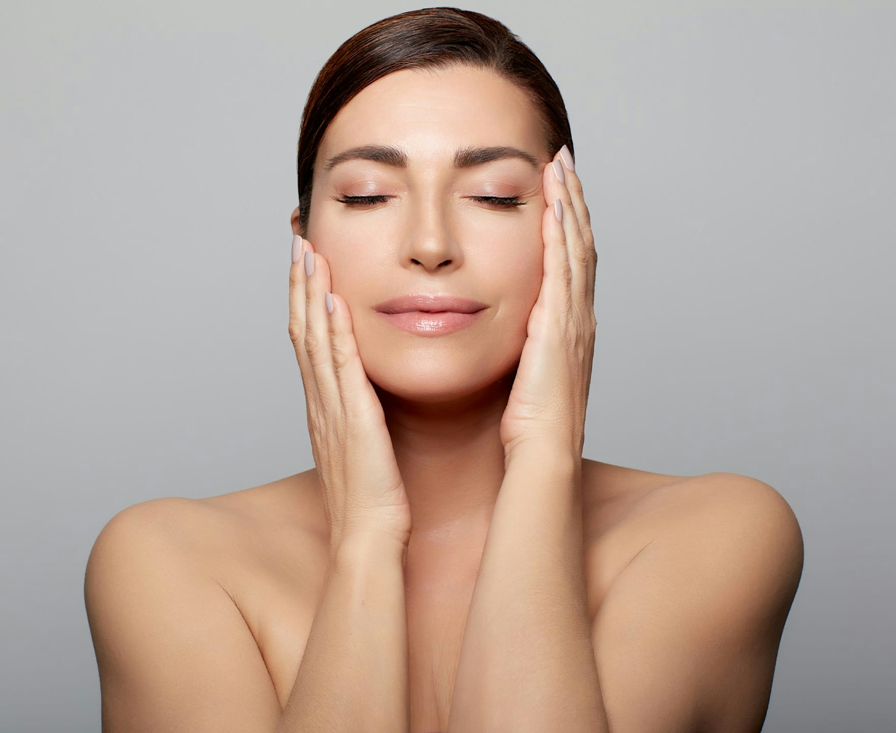 woman holding head in hands