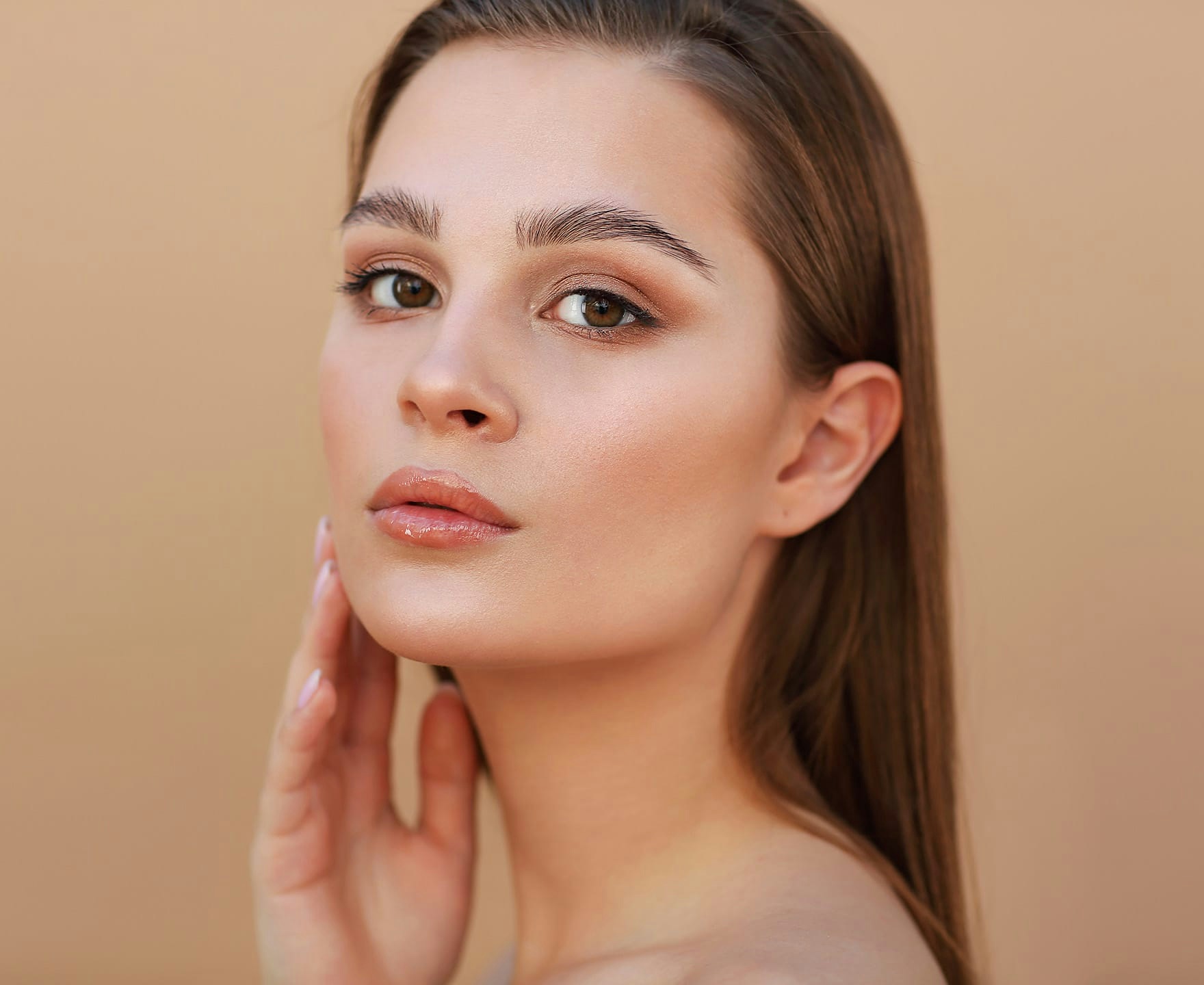 woman posing with hand on cheek