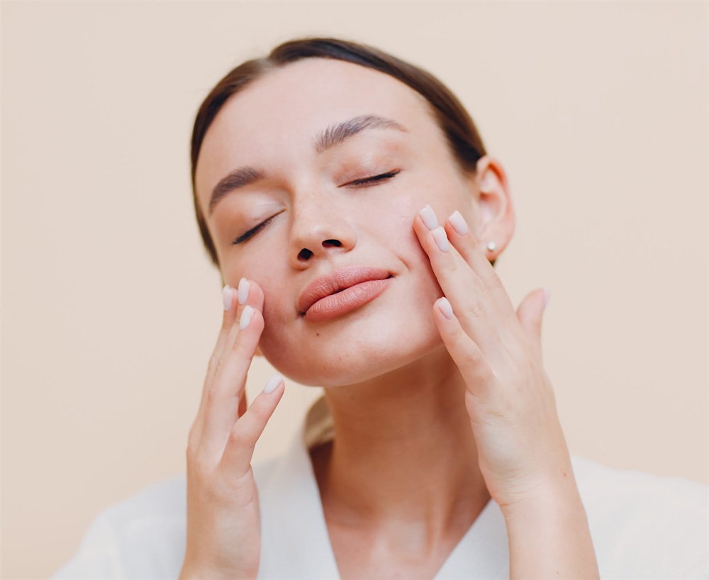 woman feeling her cheeks